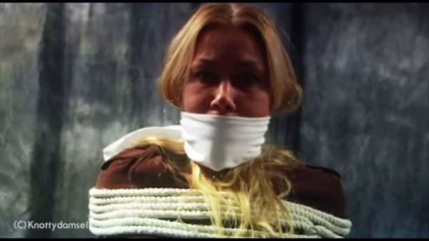 Emily Camille from She is tied to a chair and gagged with a cloth