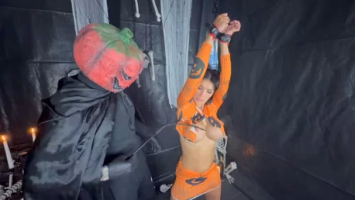 Tatti Roana's arms cuffed to chains legs ziptied to hooks