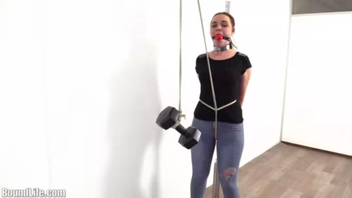 Roxy gagged and cuffed to a pole standing in high heels
